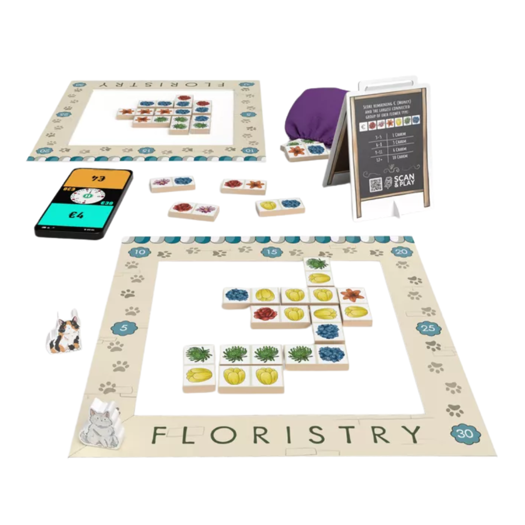 Floristry board game setup with flower tiles, bidding elements, and window display area